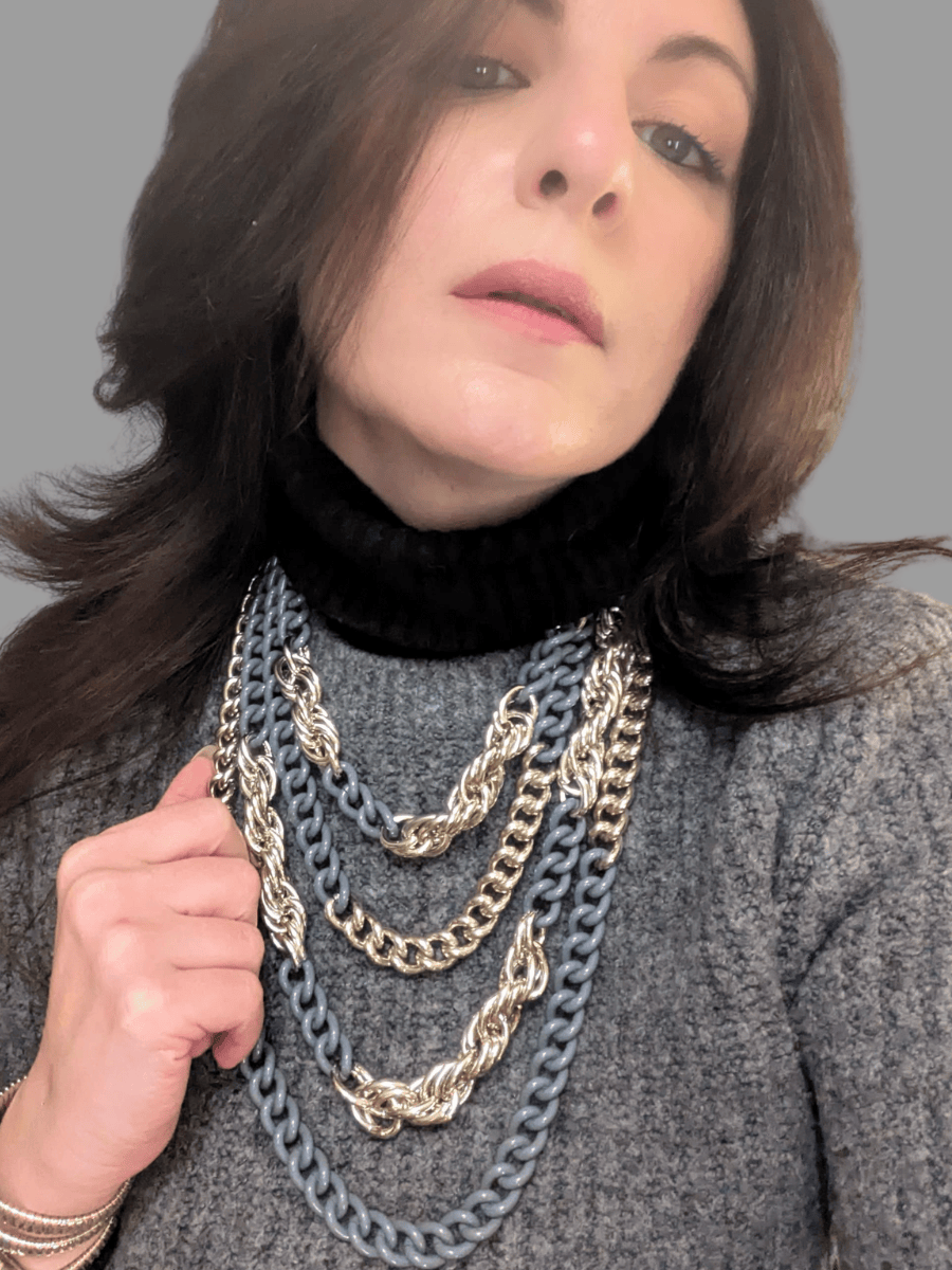 woman wearing a multi strand silver grey necklace