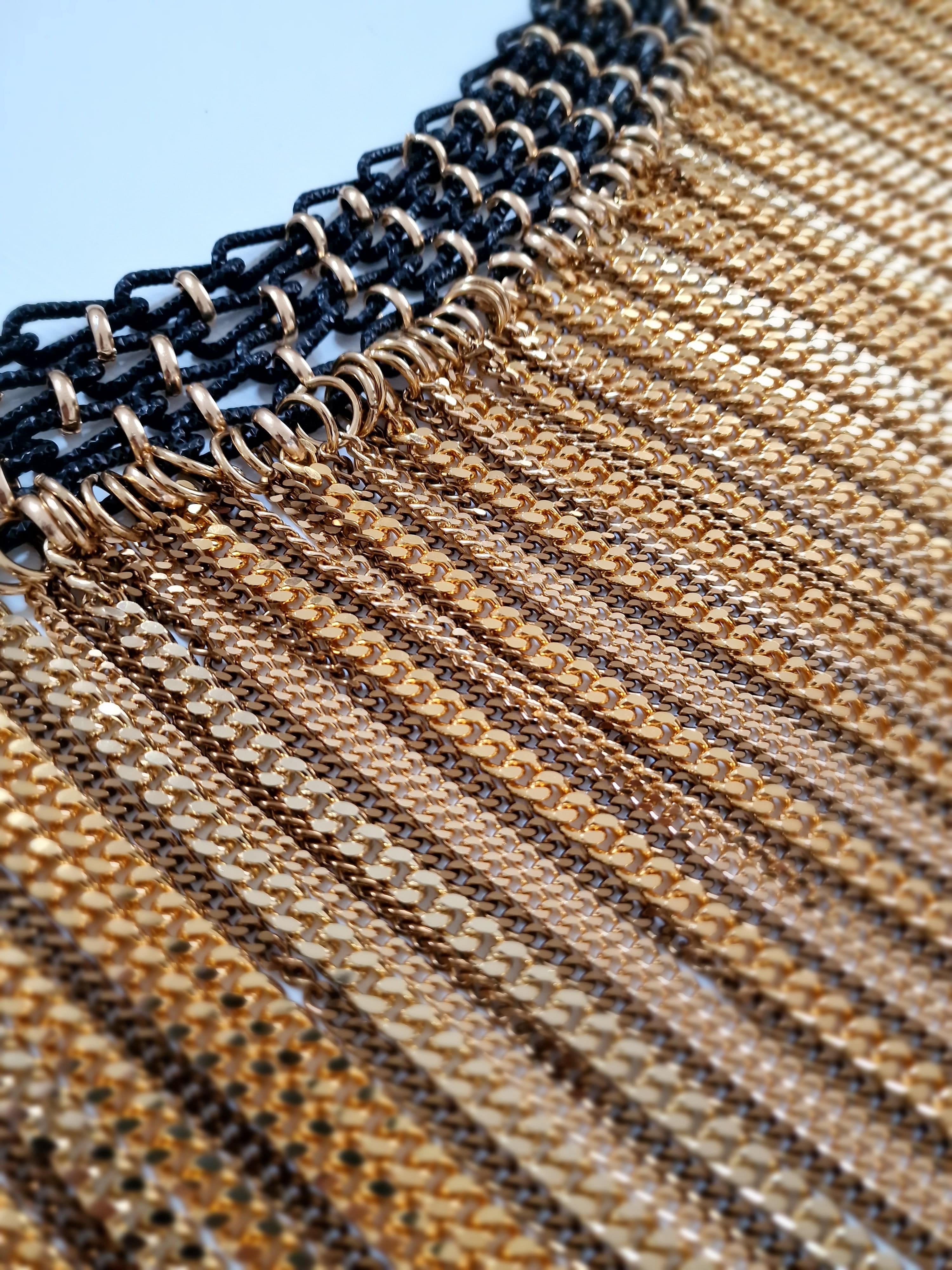 Detail of couture chain skirt in gold and bronze