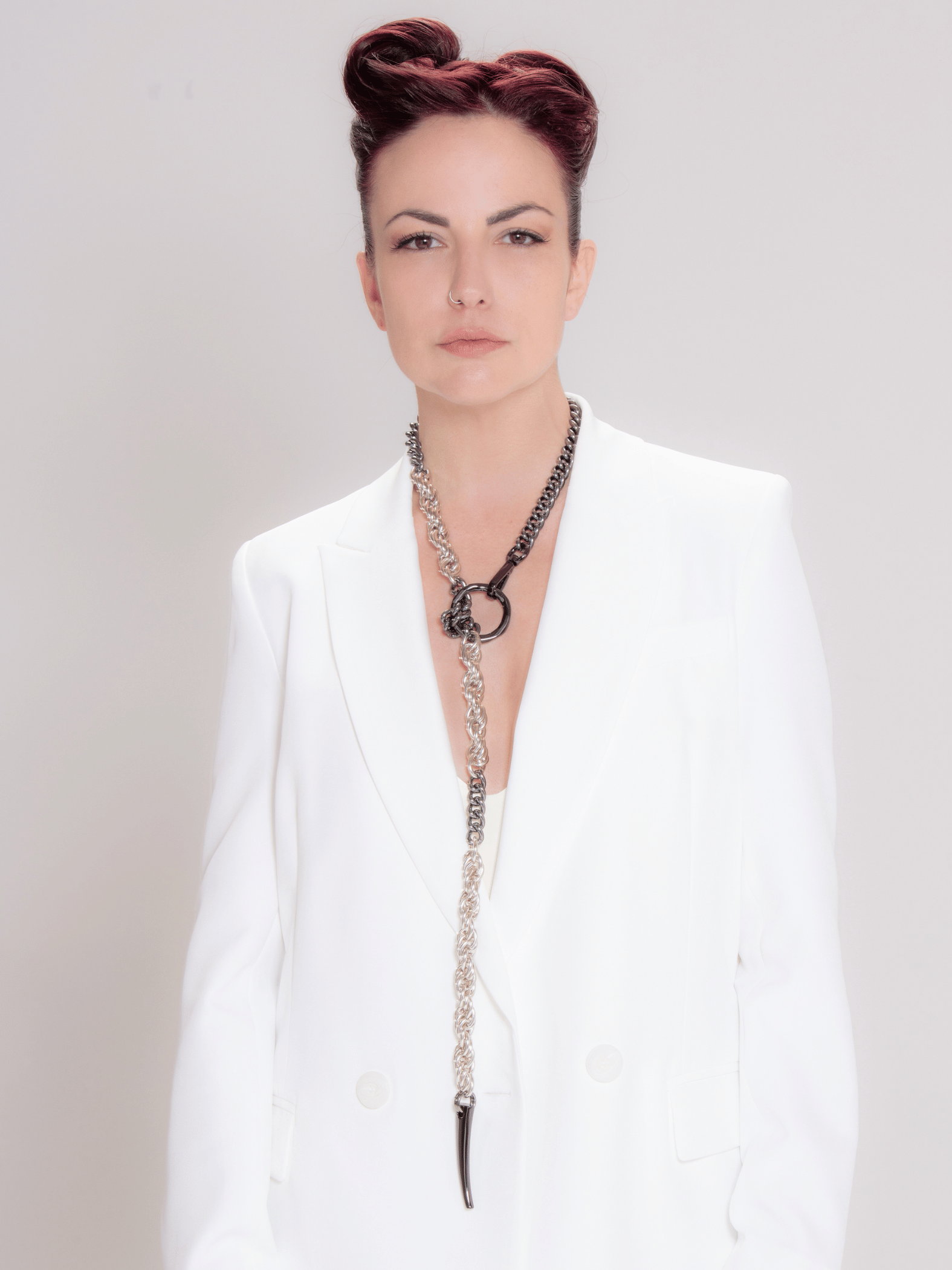 Chunky long chain necklace in silver and gunmetal worn by woman wearing white