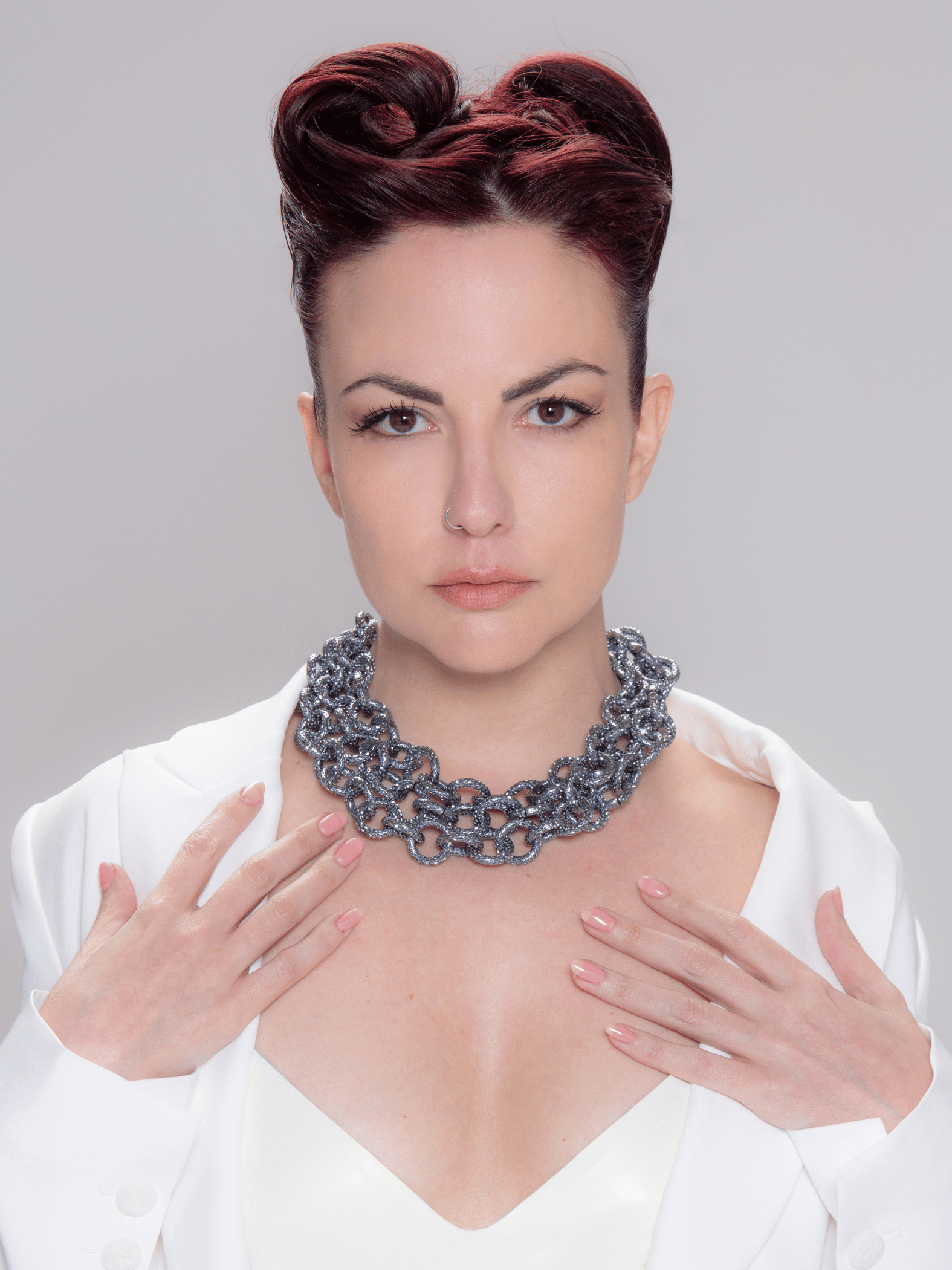 Fashion model wearing multistrand statement necklace made by chai rings in silver blue color