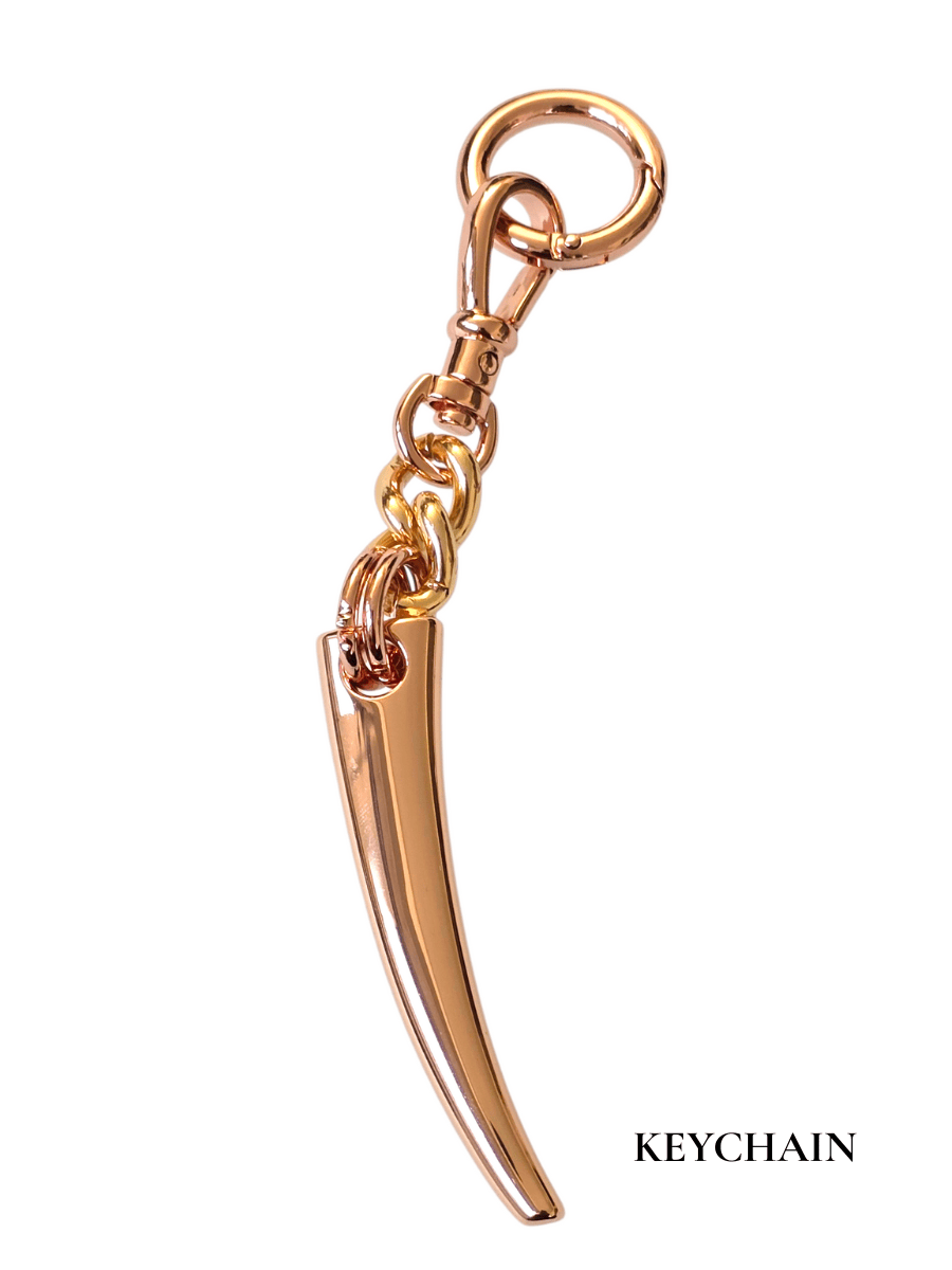Rose gold keychain with a unique design on a white background