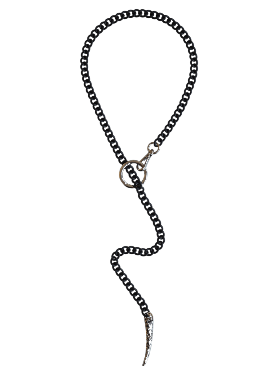 A black and silver chain necklace with a circular ring connector and a silver-toned spike pendant, displayed on a solid white background.