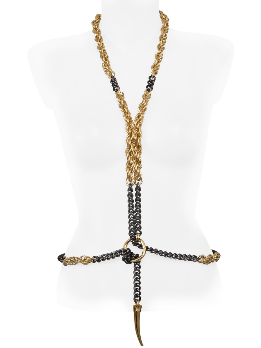 Gold and black body necklace with a unique design on a mannequin.