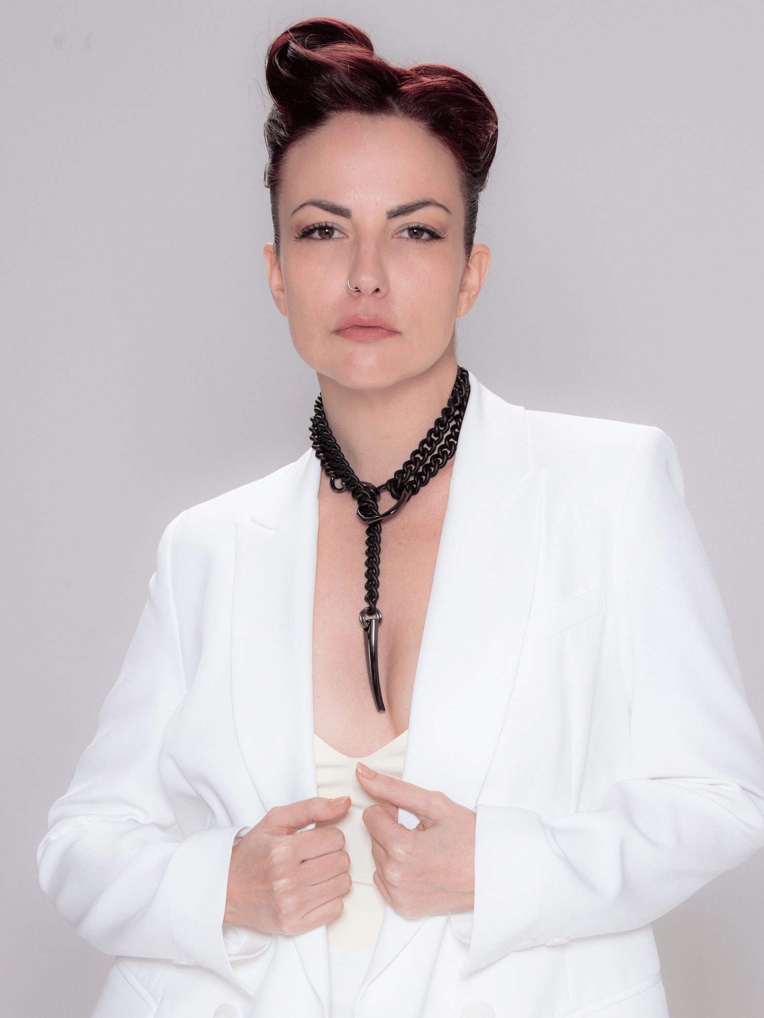 black matte gothic long chain necklace worn by model wearing white elegant jacket