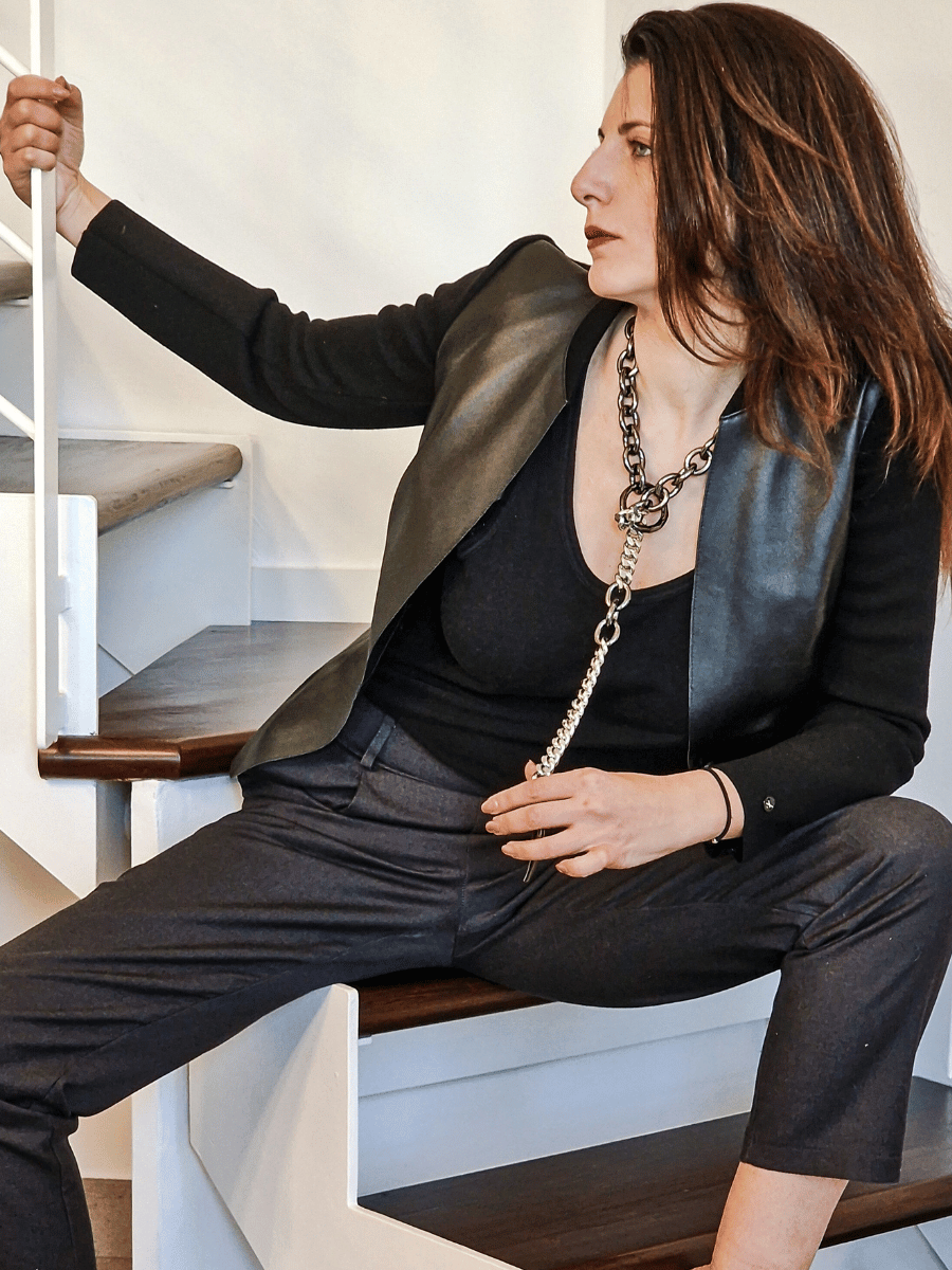 woman wearing all black and chunky apocalyptic chain necklace