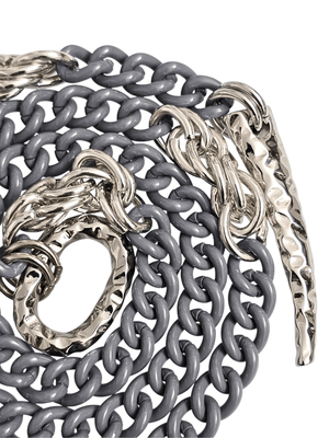 detail of silver grey chain necklace with ahmmered ring and claw pendant