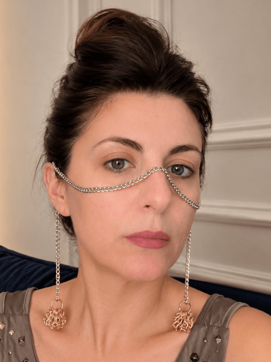 Woman wearing a decorative face chain with dangling tassels.