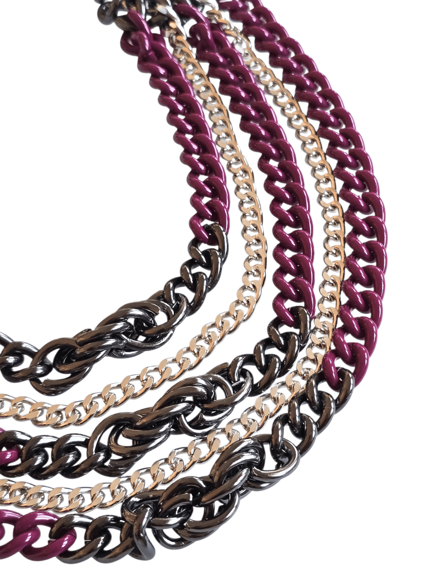 Set of chain necklaces in black, gold, and purple on a white background