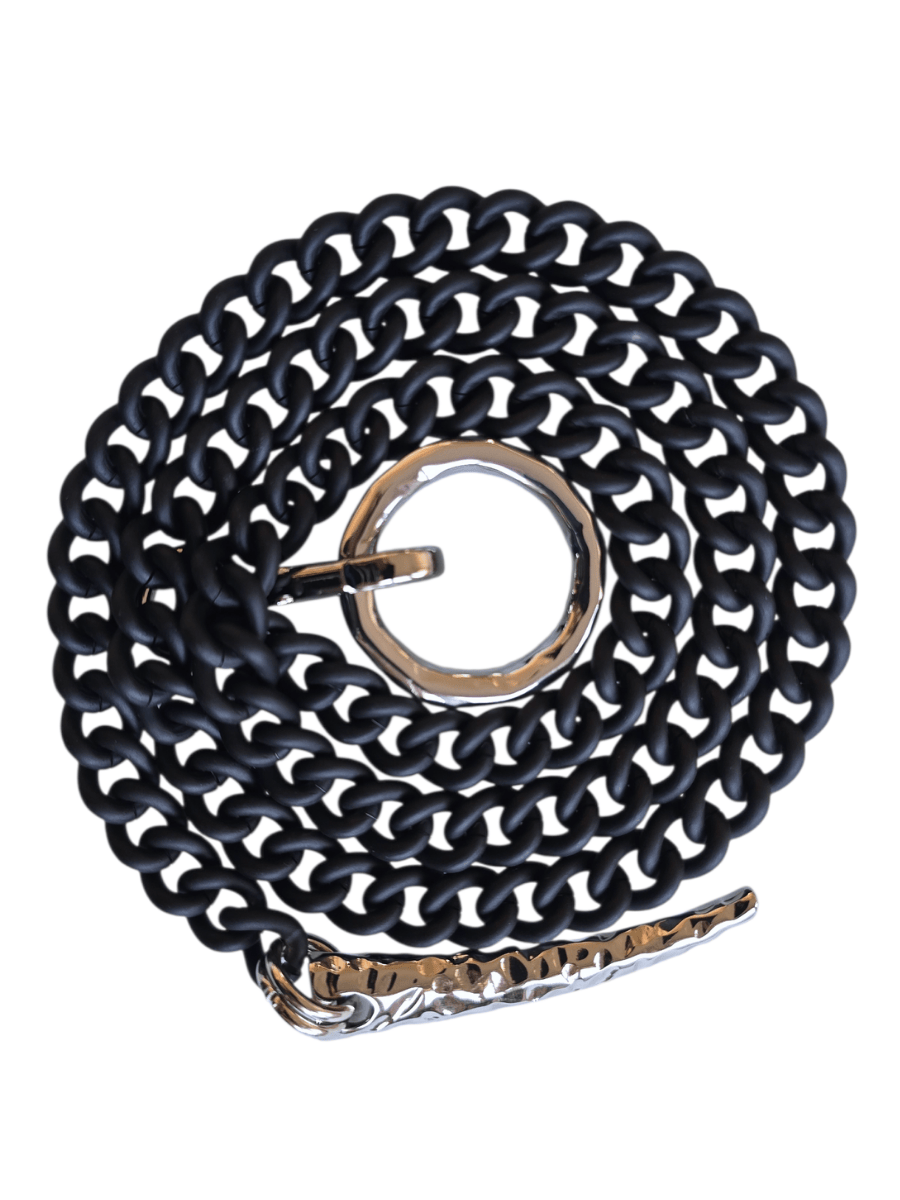 A coiled black chain necklace with polished silver-tone metal hardware, including a ring buckle and a textured keeper, shown on a plain white background.