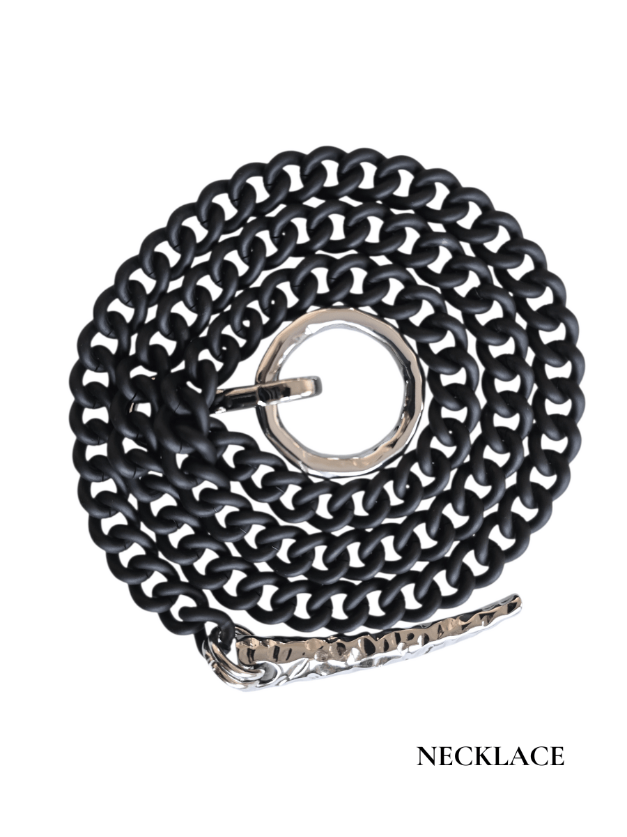 Black chain necklace  with a hammered silver horn on a white background