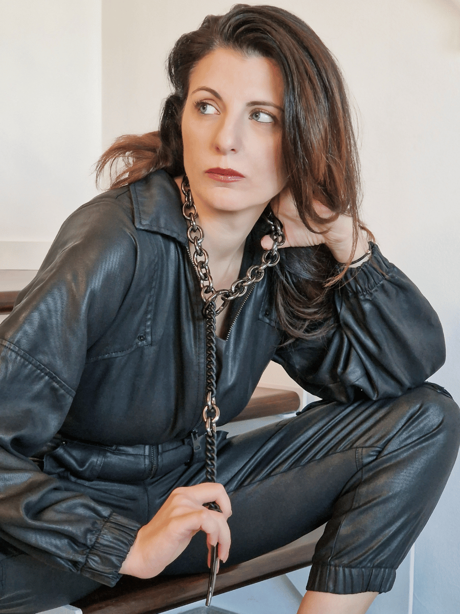 gothic chunky chain necklace on beautiful woman wearing a black playsuit