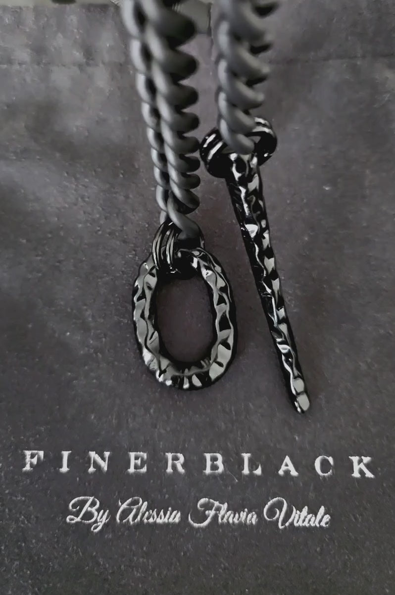 video of obsidian necklace details of black chain , claw and oval on finerblack pouch